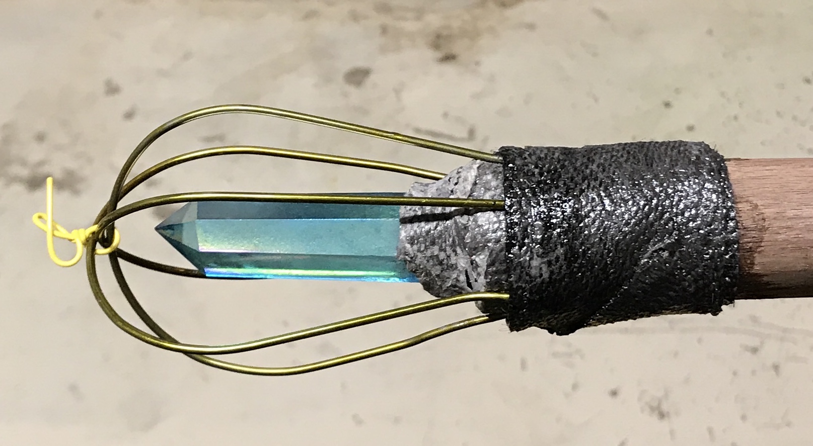 A wrapped wired cage around the crystal